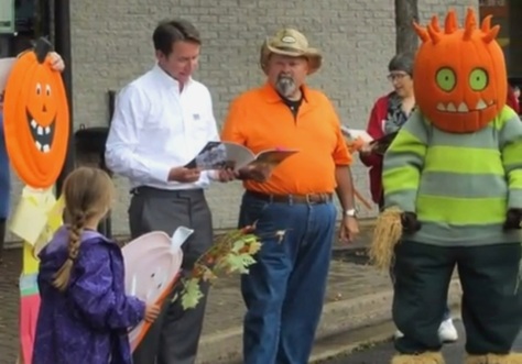 Scott Brison MP, Kentville Mayor Dave Corkum and Spike the pumpkin person perform at the StoryMob.
